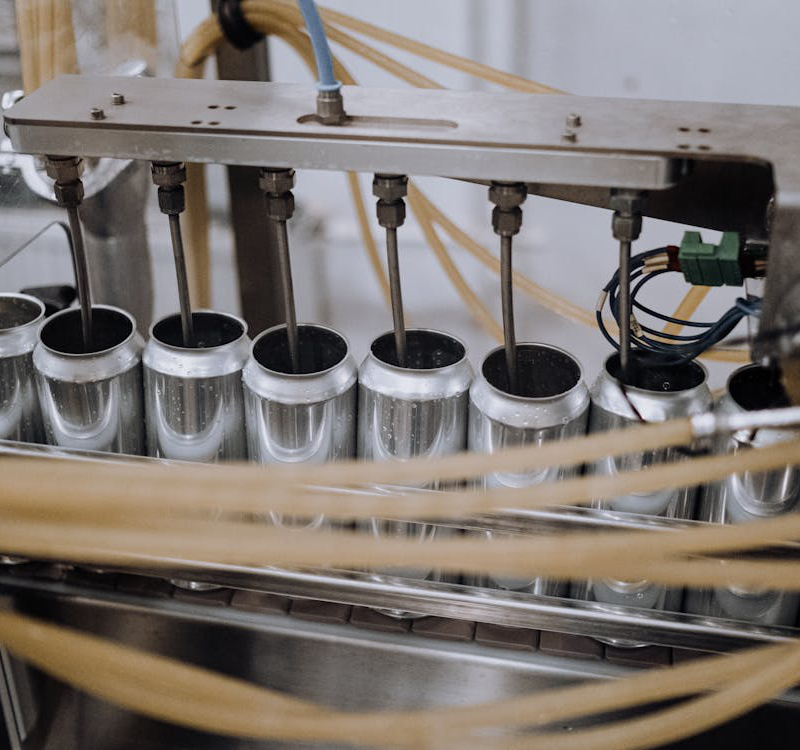 Machine filling cans in a factory