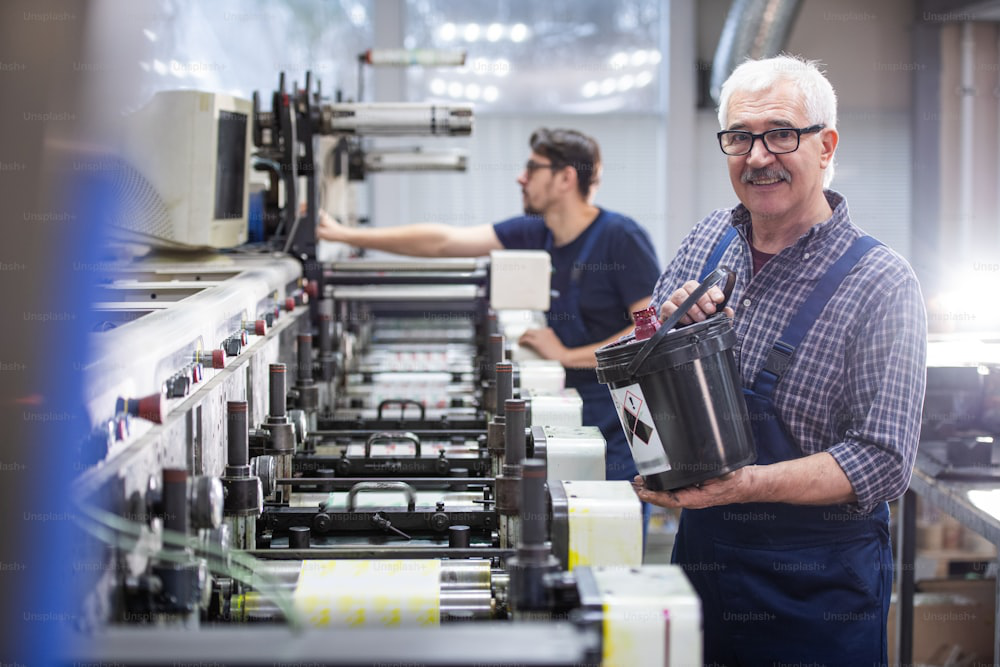 A man working at a machine in a factory