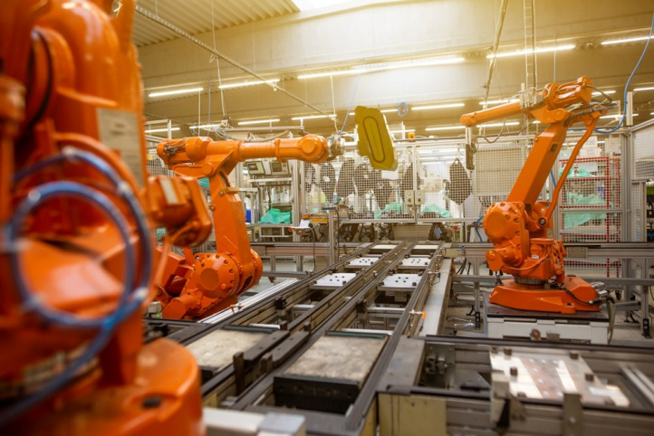 Orange material handling machines working in a factory